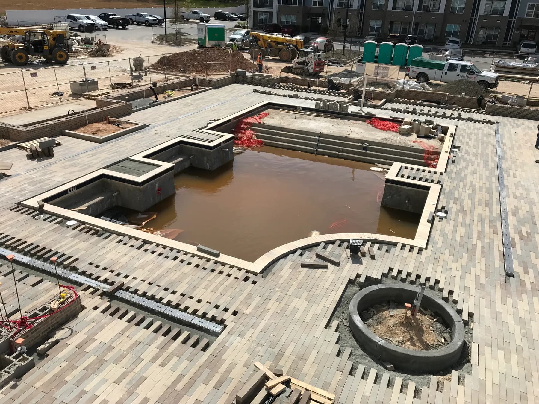 Commercial paver courtyard installation with hardscape layout and planting beds, view 3