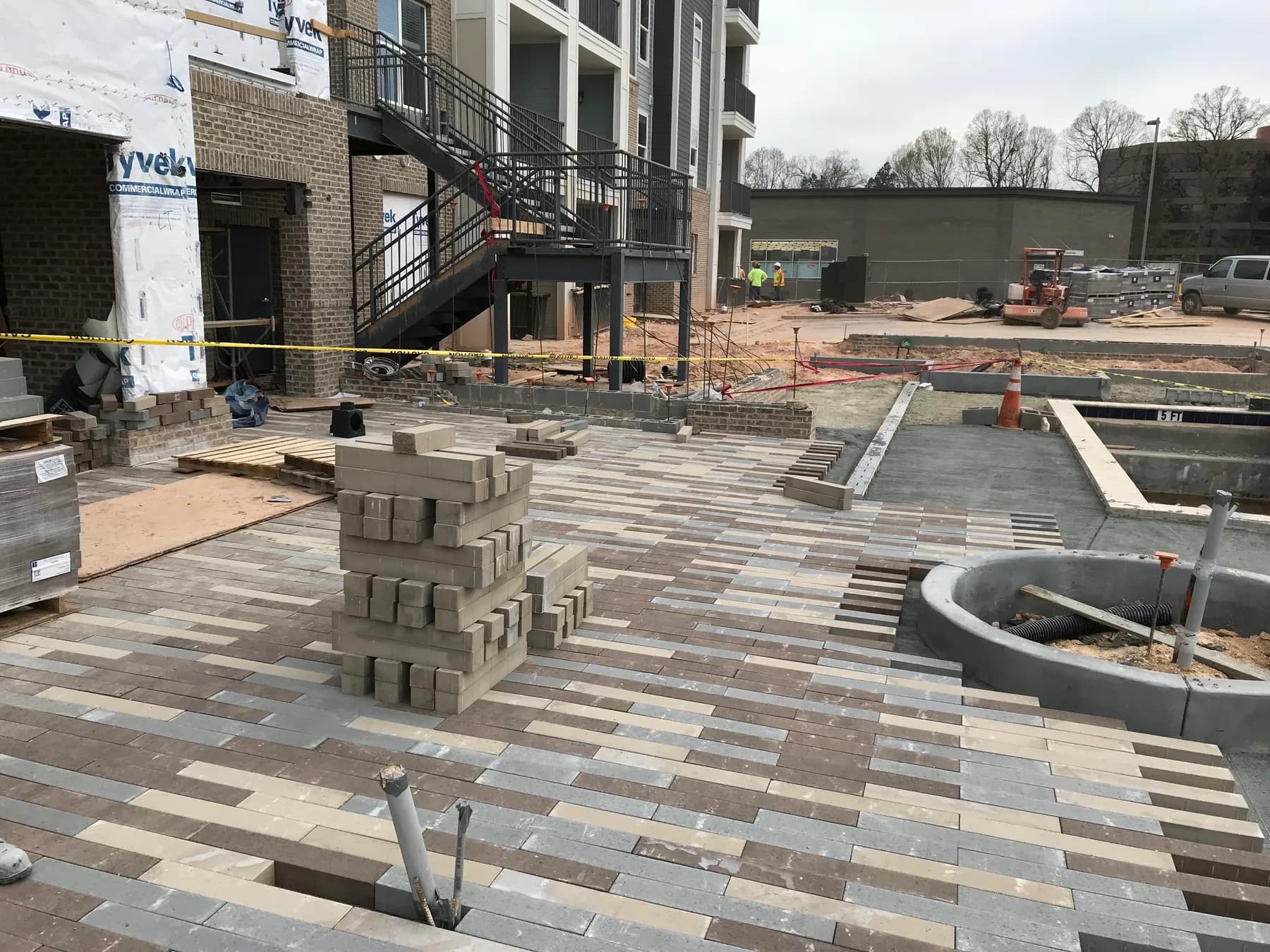 Commercial paver courtyard installation with hardscape layout and planting beds, view 4