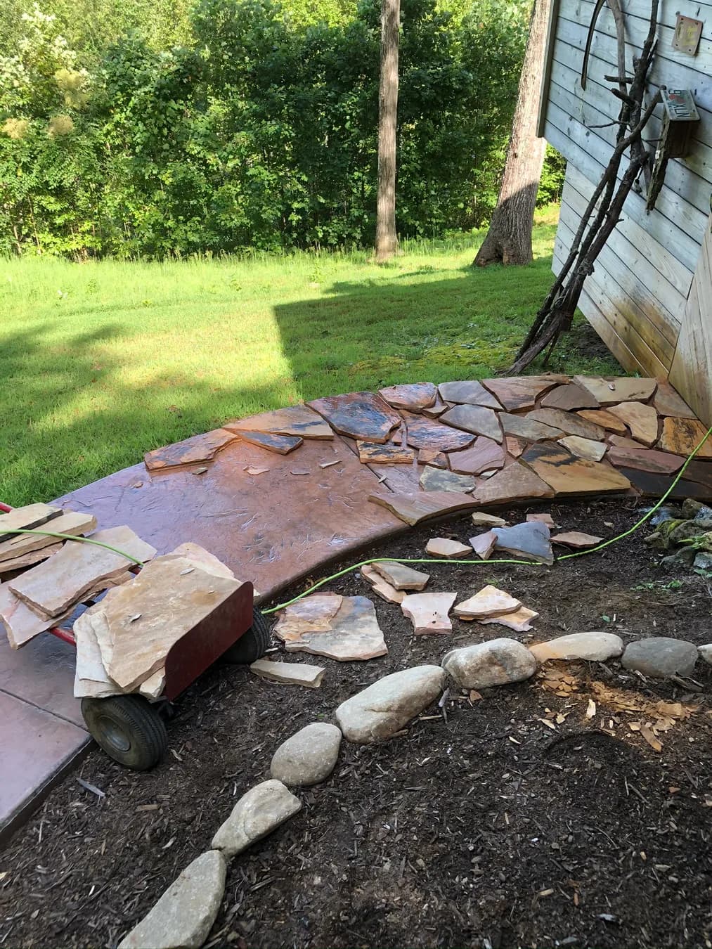 Mortared flagstone installation beginning along an existing curved walk