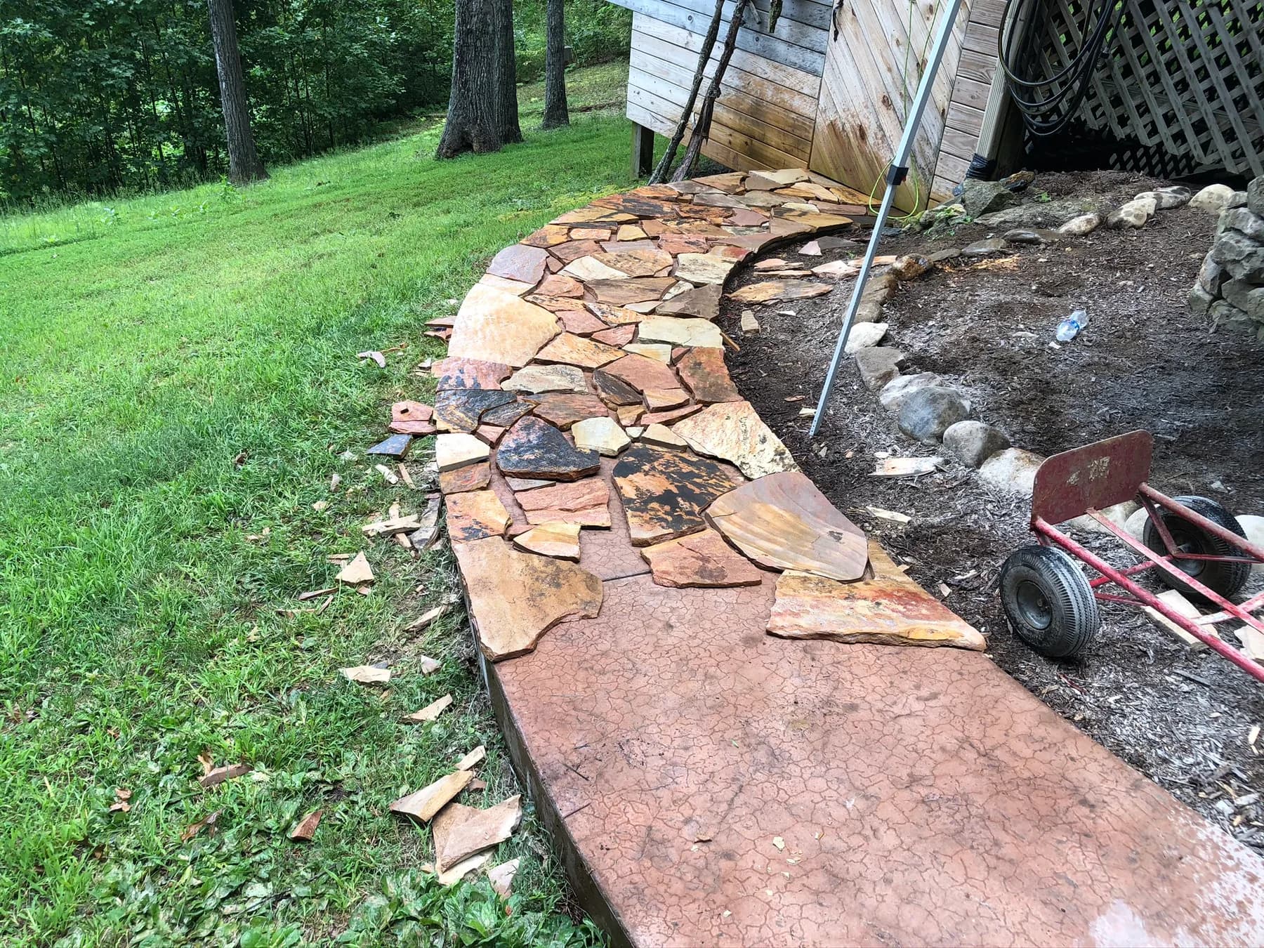 Mortared flagstone pieces laid along the curved walk edge, view 4