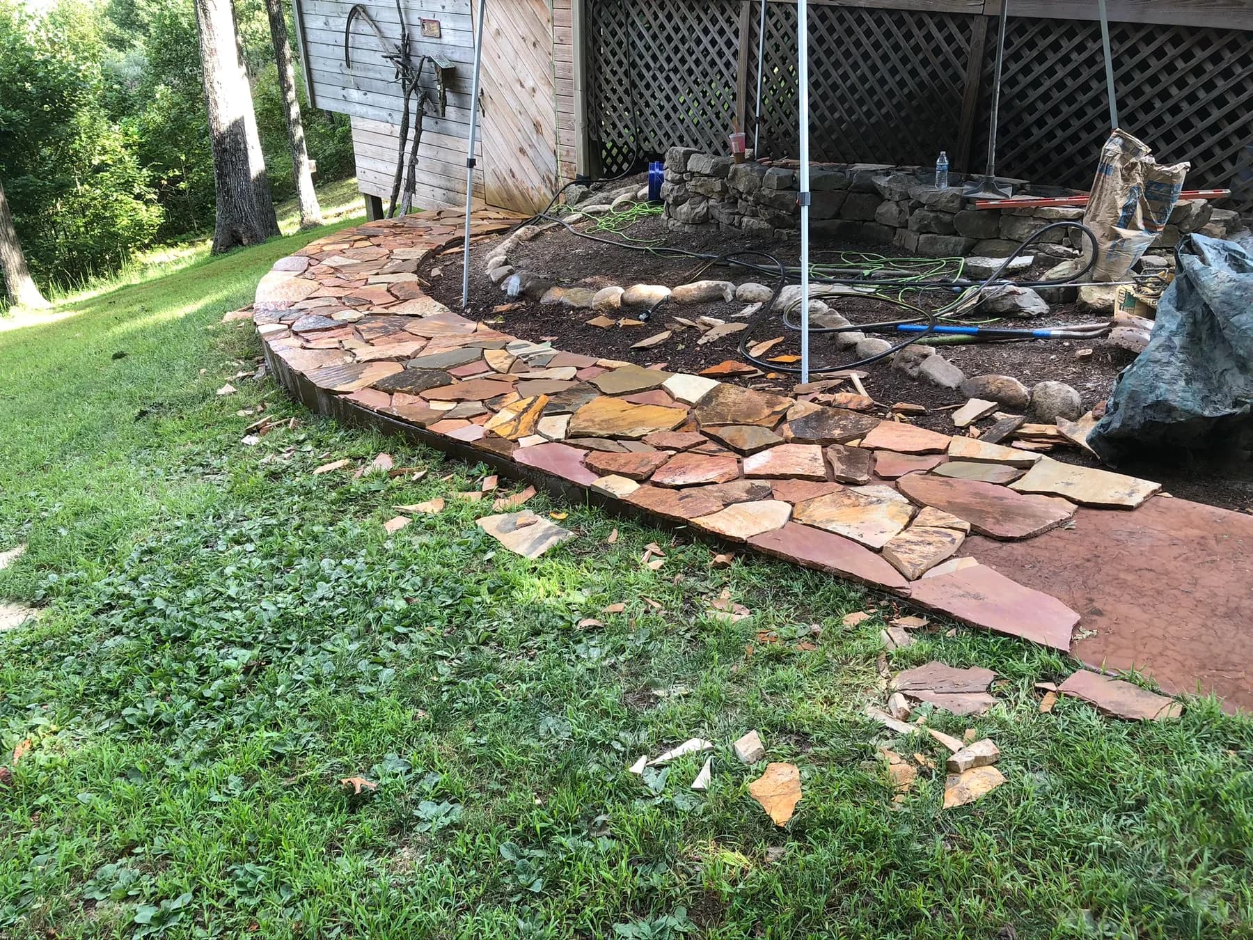 Mortared flagstone walk installation in progress along the slope, view 5