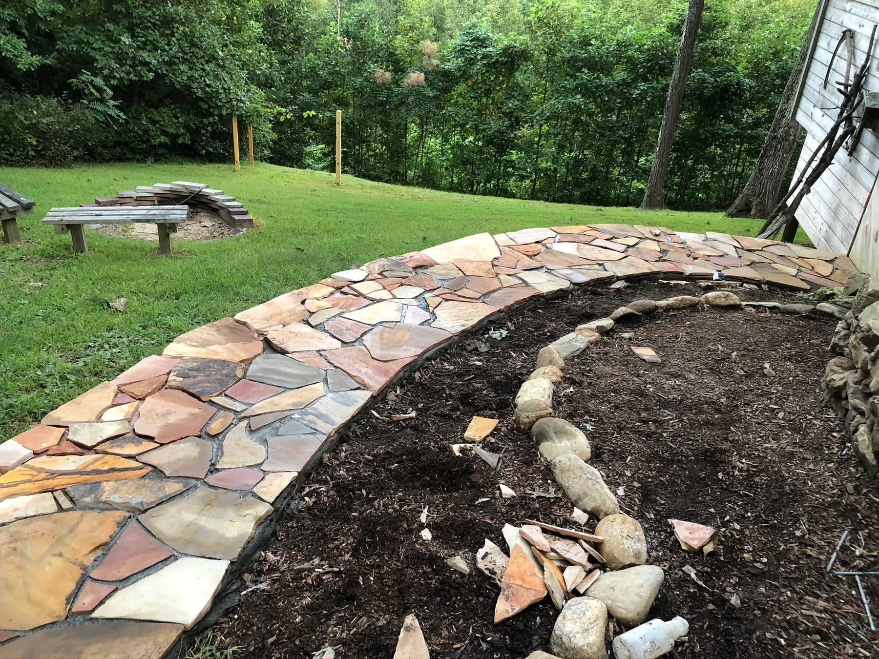 Mortared flagstone walk installation with curved stone edge, view 6
