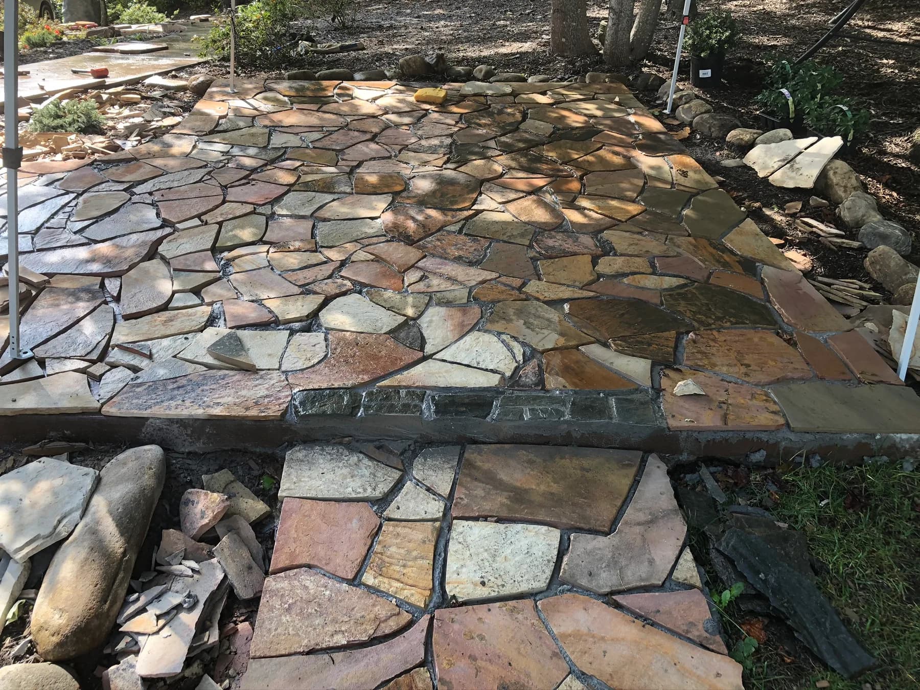 Mortared flagstone landing with stone fitment in progress, view 7