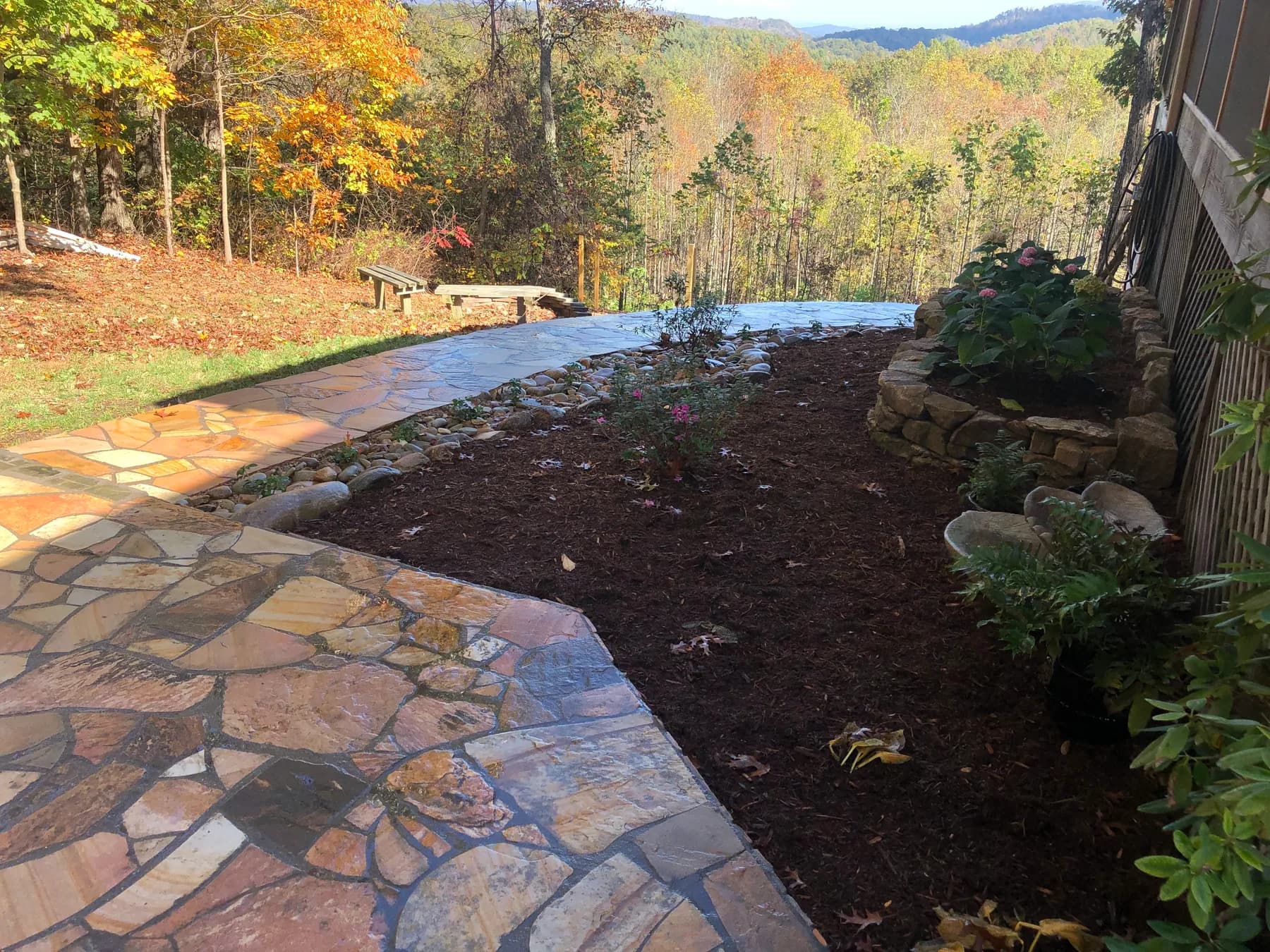 Mortared flagstone walk and terrace edge overlooking a wooded mountain site, view 15