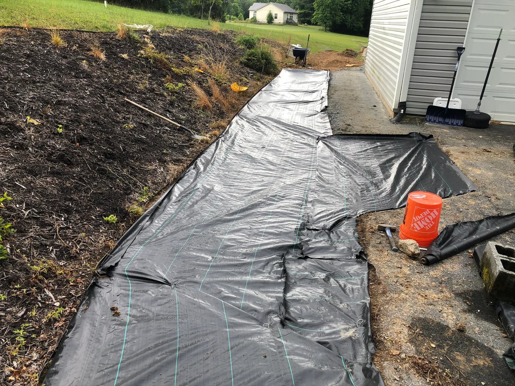 Base preparation and fabric layout for natural stone patio work