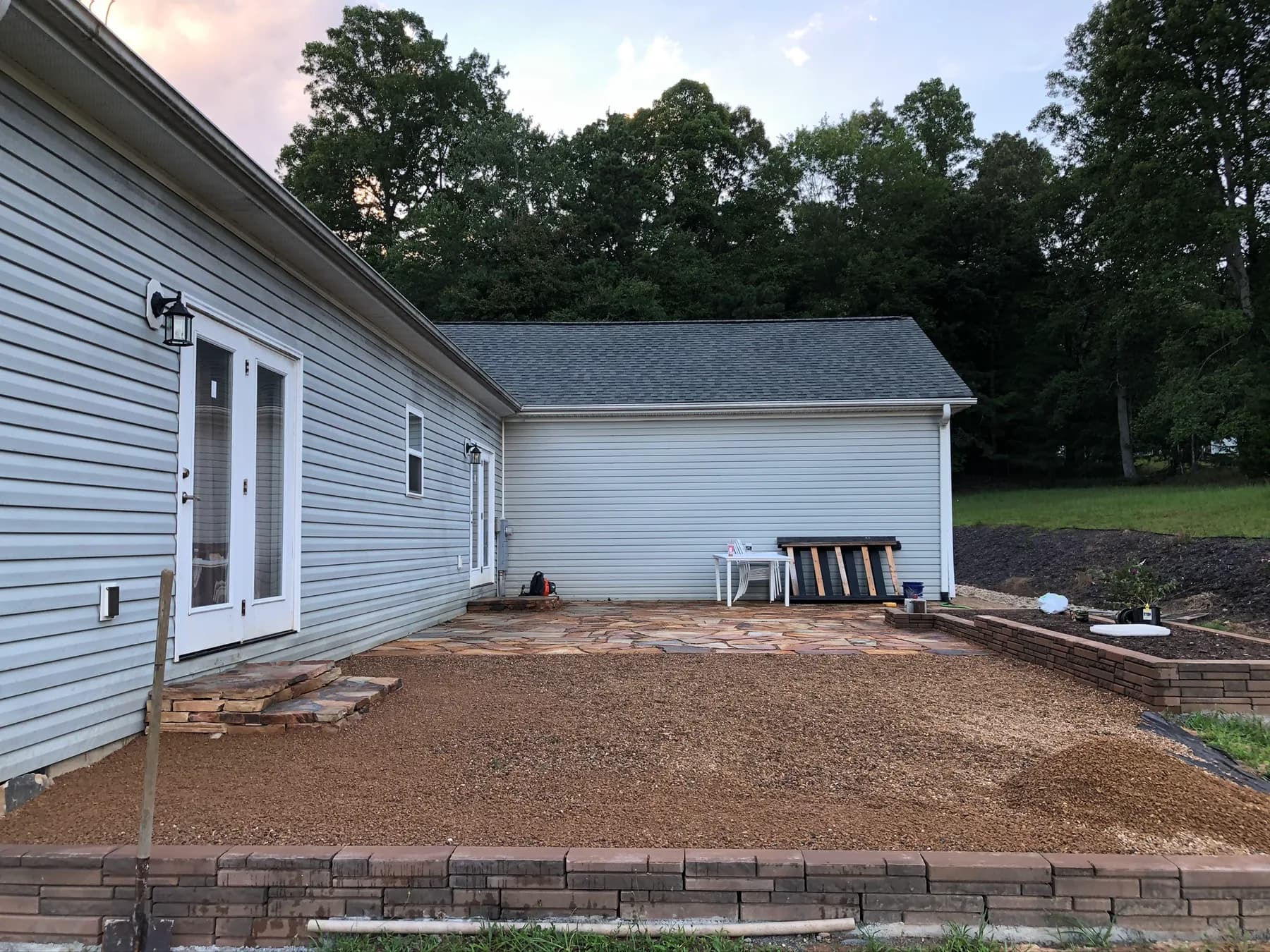 Finished natural stone patio and step transition with gravel surface tie-in
