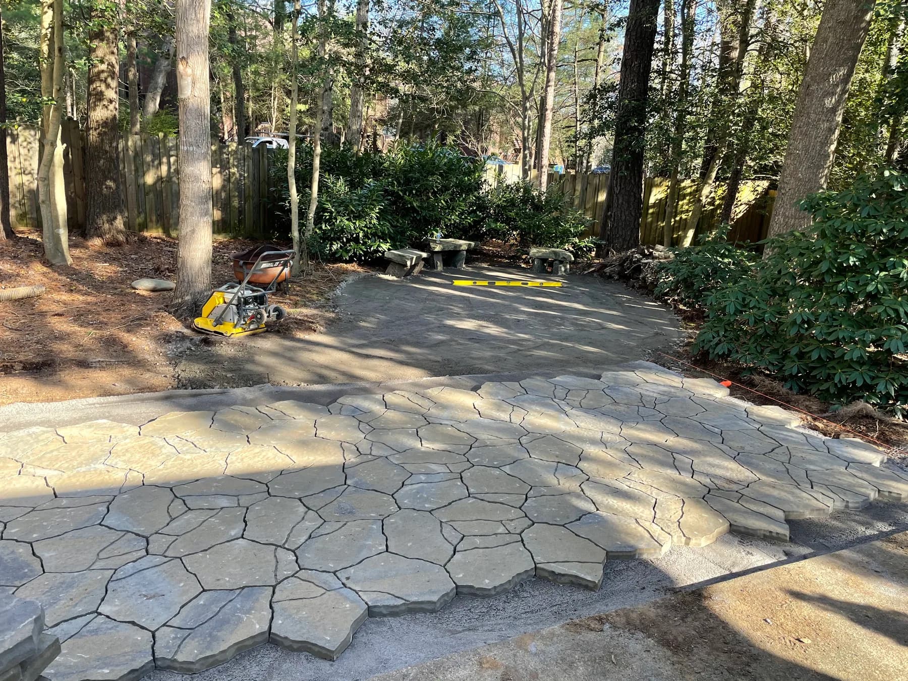 Woodland stone patio project with stone surfacing, border work, and outdoor seating area, view 6