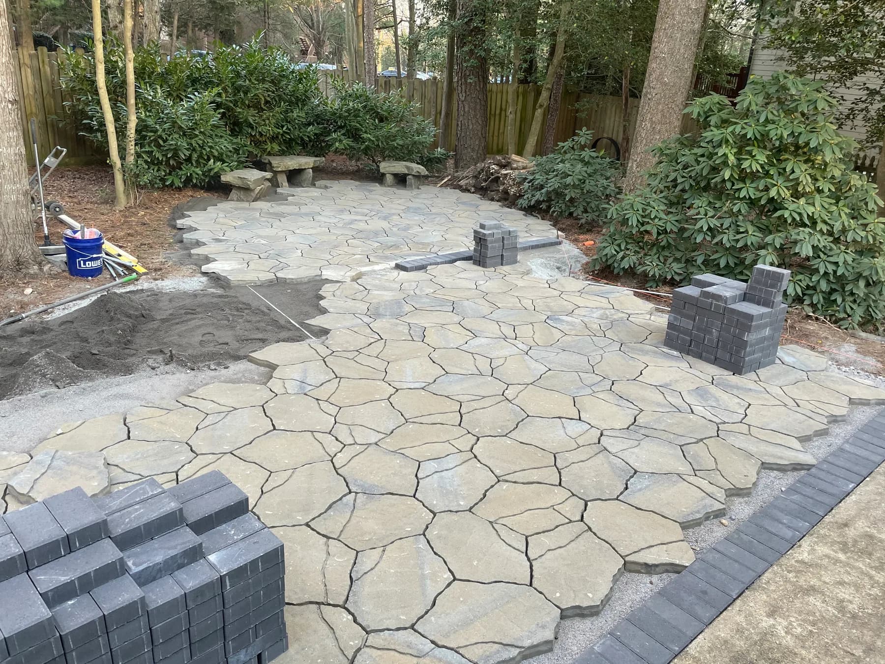 Woodland stone patio project with stone surfacing, border work, and outdoor seating area, view 8