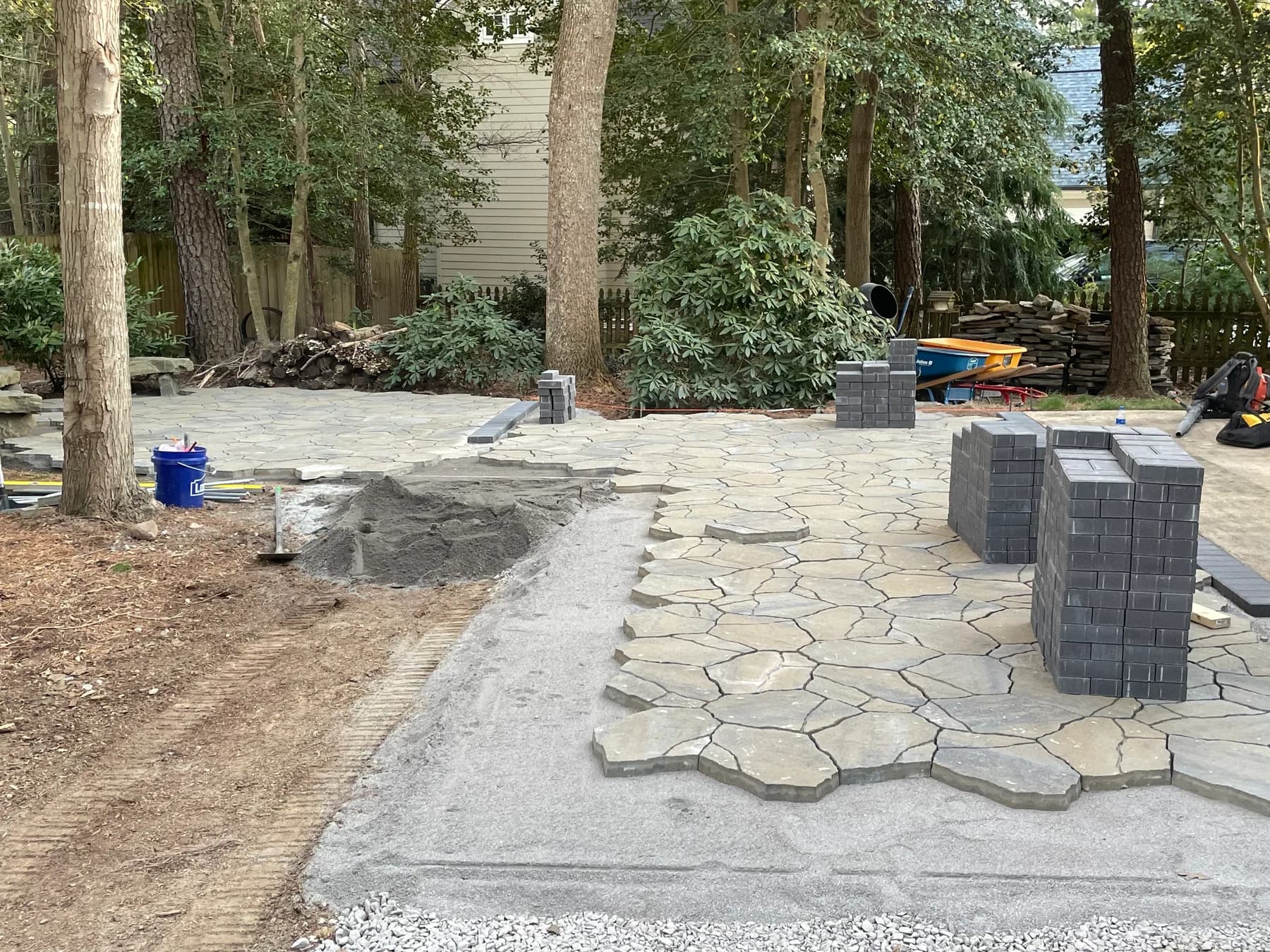 Woodland stone patio project with stone surfacing, border work, and outdoor seating area, view 9
