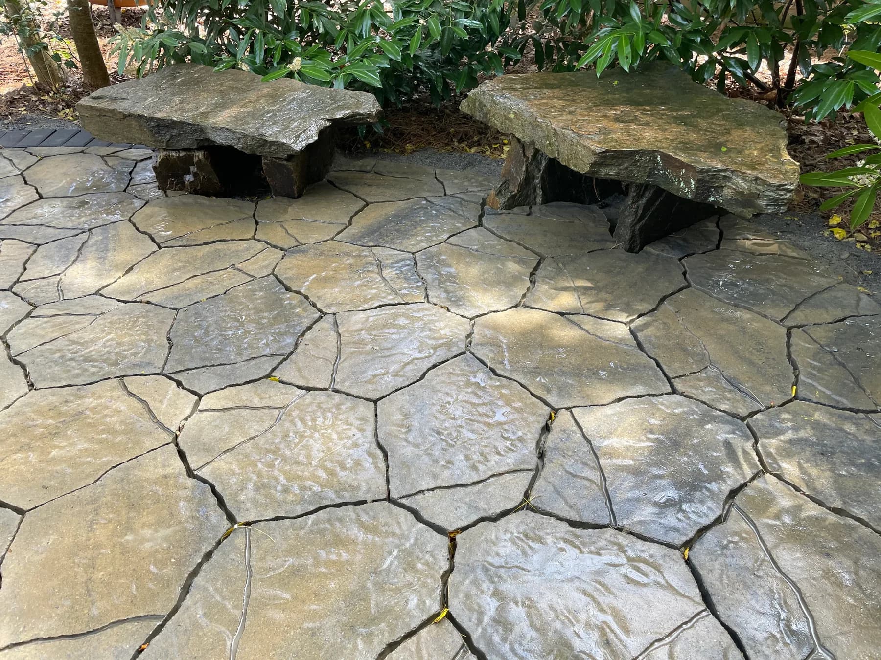 Woodland paver patio with natural stone seating detail, view 11