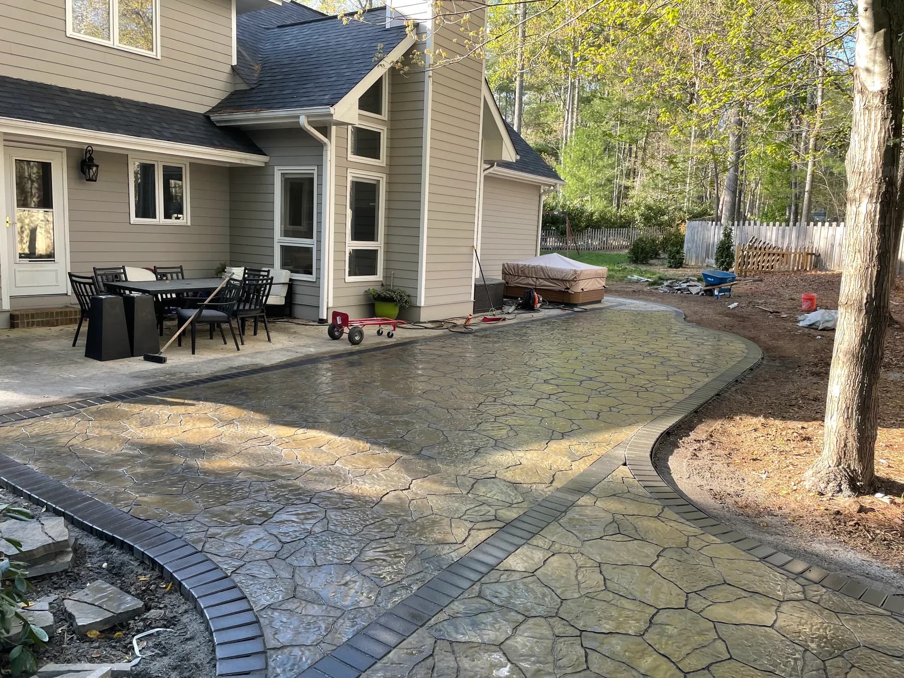 Woodland stone patio project with stone surfacing, border work, and outdoor seating area, view 13