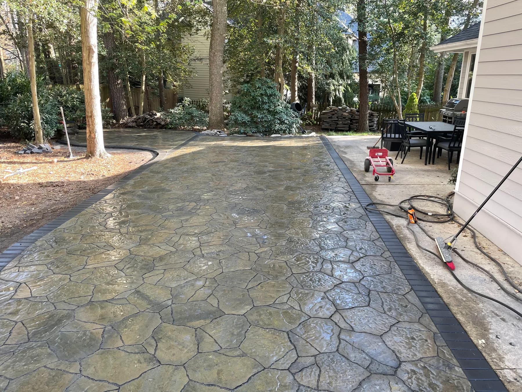 Long view of woodland paver patio with border courses