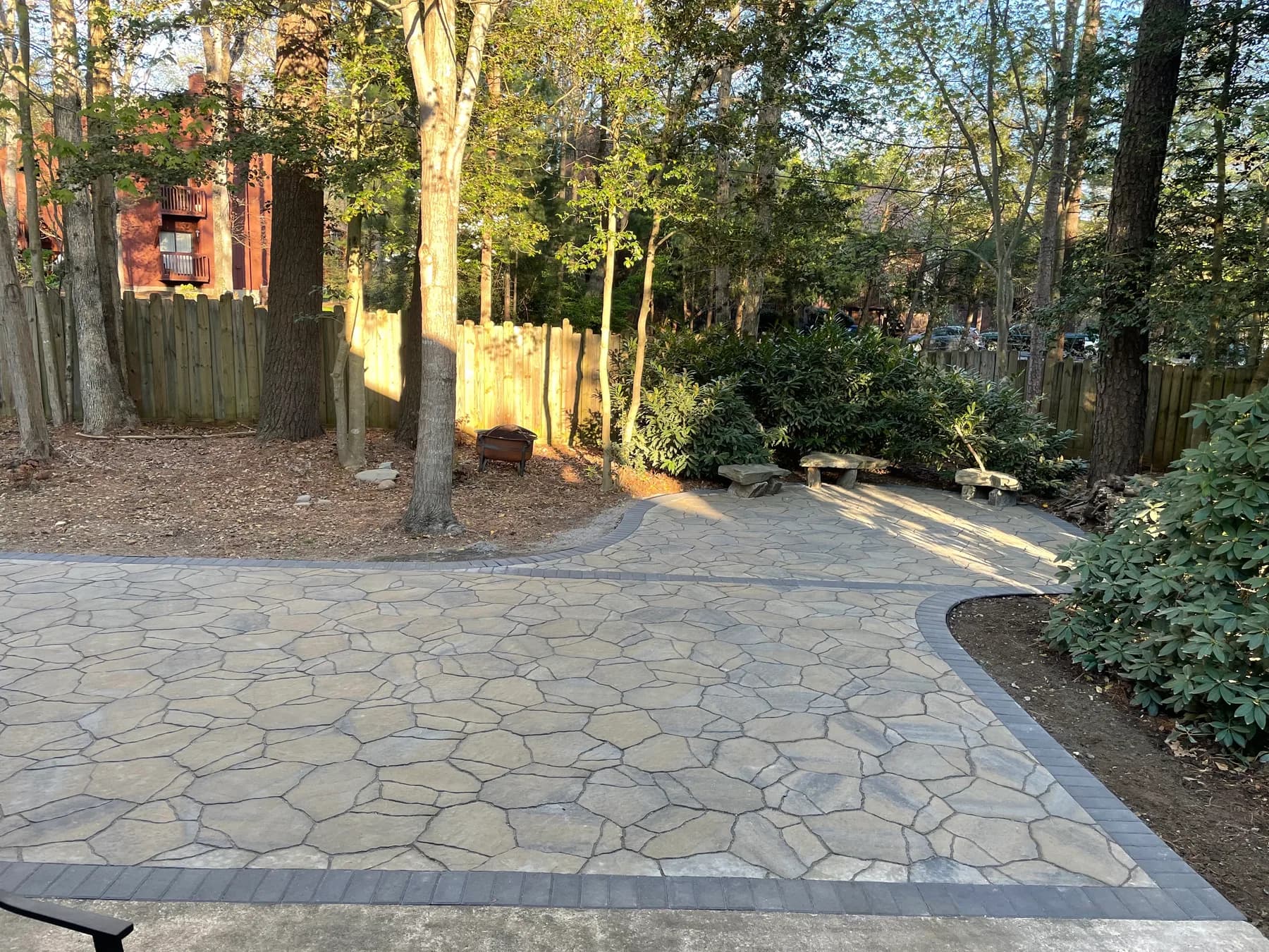 Woodland stone patio project with stone surfacing, border work, and outdoor seating area, view 15