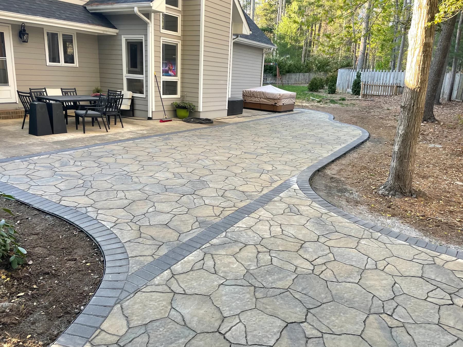 Woodland stone patio project with stone surfacing, border work, and outdoor seating area, view 16