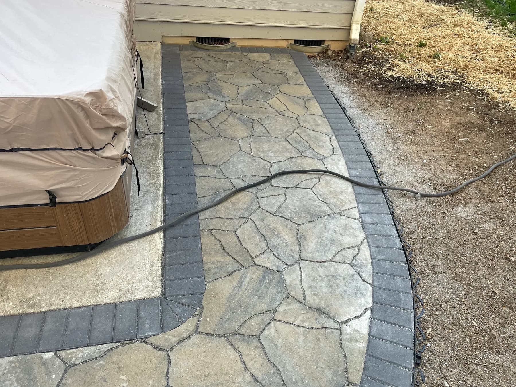 Woodland stone patio project with stone surfacing, border work, and outdoor seating area, view 18